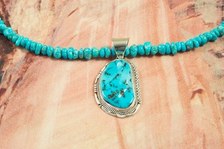 Beautiful Sleeping Beauty Turquoise set in Sterling Silver Pendant on a Necklace featuring Genuine Sleeping Beauty Turquoise with Sterling Silver Cones and Clasp. Created by Navajo Artist John Nelson. The Sleeping Beauty Turquoise Mine is located in Gila County, Arizona. 